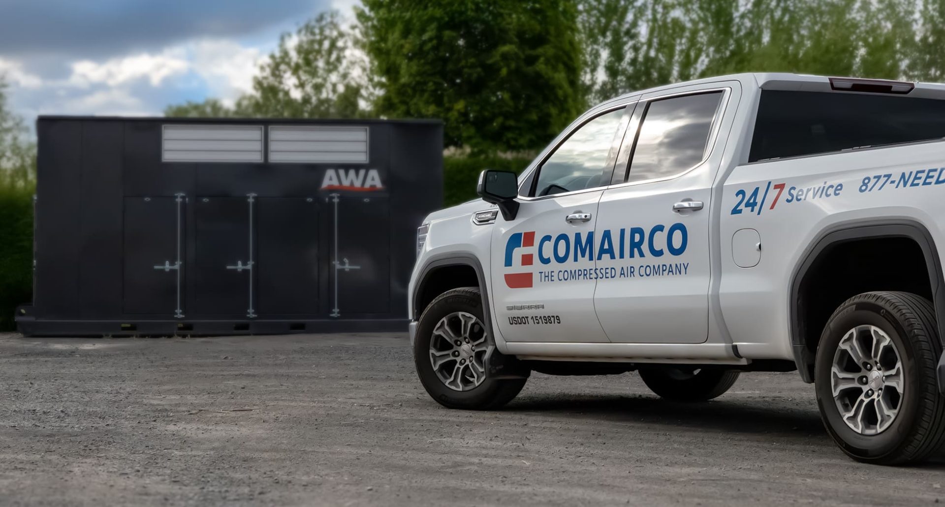 COMAIRCO service truck positioned beside an AWA outdoor compressed air enclosure